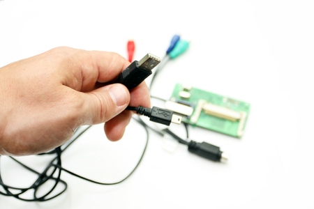 The interface USB, miniUSB, HDMI in a hand on a white background with chips