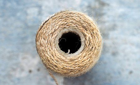 Round ball with a natural woolen thread on a gray backgroundの写真素材