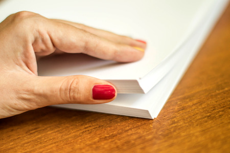 The process of turning white office paper on the desktopの写真素材