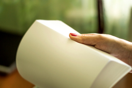 The process of turning white office paper on the desktopの写真素材