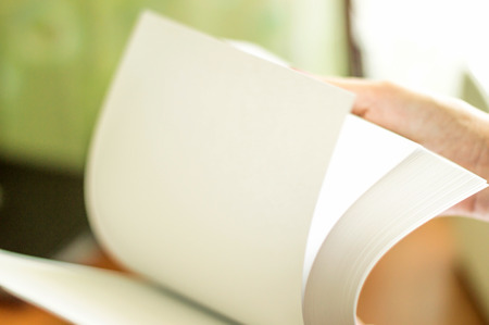 The process of turning white office paper on the desktopの写真素材