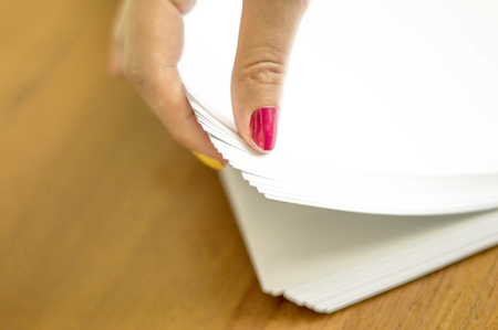 The process of turning white office paper on the desktopの写真素材