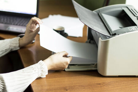 The process of inserting paper in laser printer cartridge on an Office background