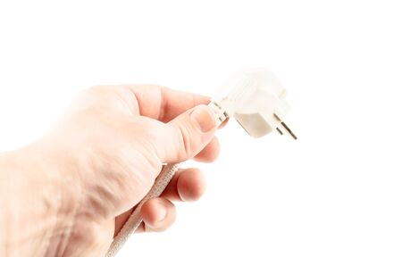 White plug in hand on a white background