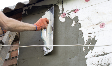 The process of applying putty to the  polyfoam wall using a spatulaの写真素材