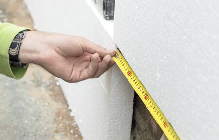 Master measures the length of foam plastic for installation