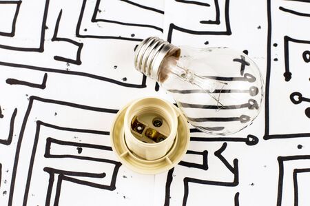Incandescent lamp with a chuck on the background of the picture with microchipsの写真素材