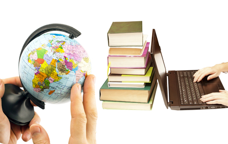 Political globe in the hands on the background of various books and laptopの写真素材