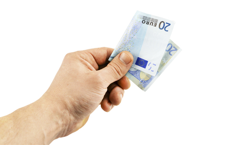 Banknote in denomination of 20 euro in  hand on a white backgroundの写真素材