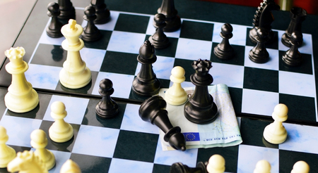 The game of chess and the European currency on the boardの写真素材