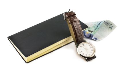 The euro, notebook and wristwatch on a white backgroundの写真素材