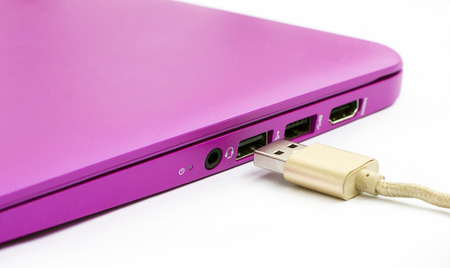 The process of connecting the Universal Serial Bus  to the notebook on a white backgroundの写真素材