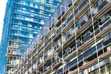 Reconstruction of the facade of a modern apartment building against the skyの写真素材