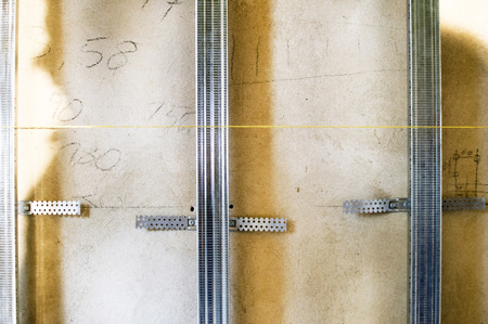 Installation of metal profile for attaching drywall to the wallの写真素材
