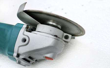 Angle Grinder with a protective casing on a background of white polystyrene