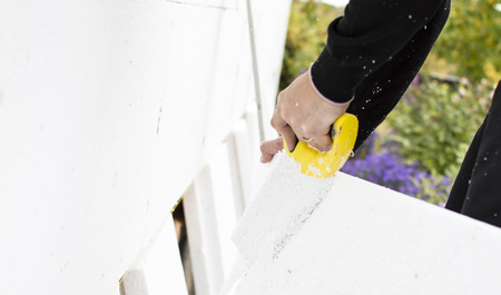 The process of cutting with saws of foam plastic on the background of open spaceの写真素材