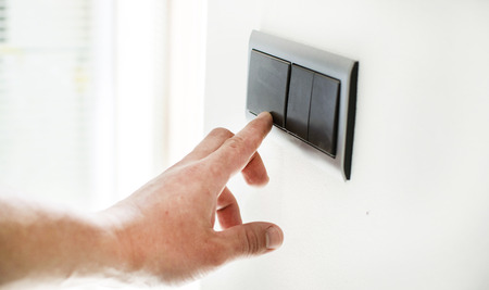 The process of turning on the light by a switch on the wall
