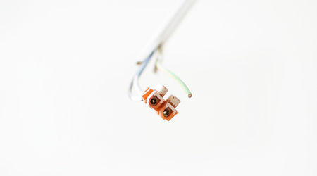 The output of electric cables in a room on the background of the white wall
