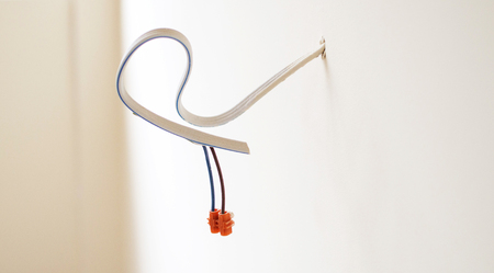 The output of electric cables in a room on the background of the white wall