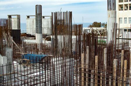 The construction of the foundation and concrete rebar against a background of blue sky