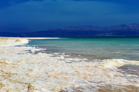 Dead Sea of salt on coast on a background of mountainsの写真素材
