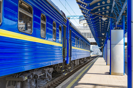 The blue train cars at the station waiting for departure