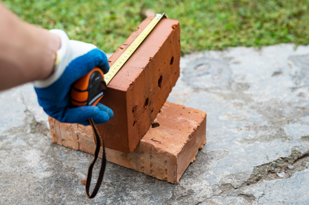 The process of measuring the size of red bricks using rouletteの写真素材