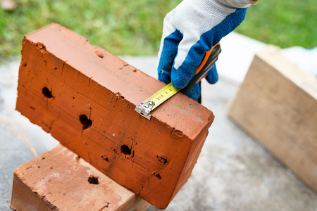 The process of measuring the size of red bricks using rouletteの写真素材