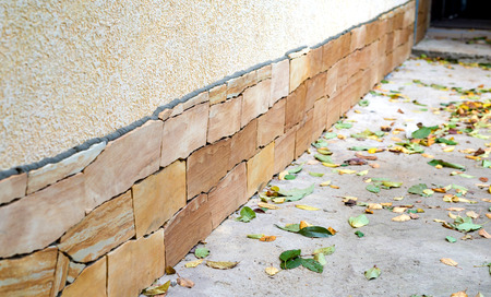 The look of the foundation of the house is covered with a yellow sandstone from the outside
