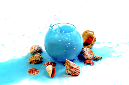 Imitation spray blue liquid in a glass globular vase on the marine themeの写真素材