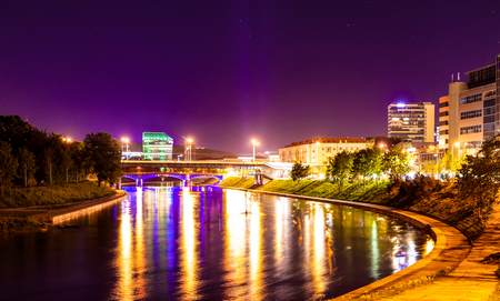 Beautiful night landscape - a river with houses on the beach in the cityの写真素材