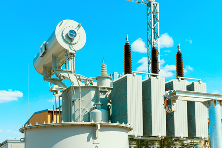 110 kV high voltage transformer in the electric substation on the blue sky background