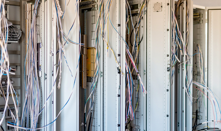 Relay room with a variety of distribution equipment and wiring in the process of installation