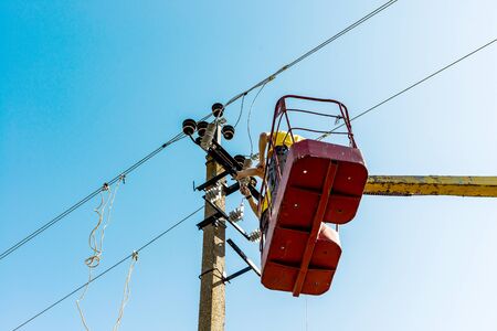 The process of installing an electrical disconnect switch on a transmission line support using a...