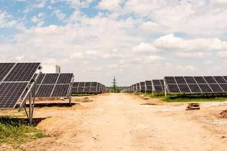 Section sections of solar panels on the background of a blue sky with white cloudsの写真素材