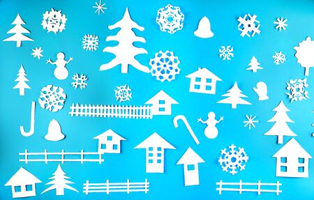 Applique of various Christmas-themed figures cut out of white paper on blue backgroundの写真素材