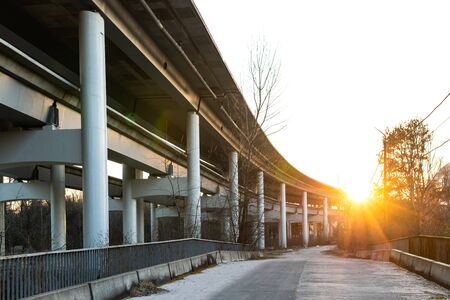 Reinforced concrete bridge view from below on a background of sun raysの写真素材