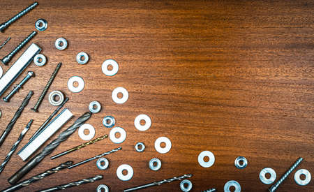 Rear view - a woman with long hair peeks out the window through the curtains of blue blindsの写真素材