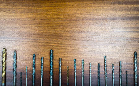 Set of hexagonal metal chrome heads for ratchet key on brown wood texture backgroundの写真素材