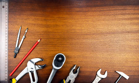 Knolling style photo - various items and tools for home repair on a background of brown wood textureの写真素材