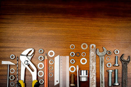 Knolling style photo - various items and tools for home repair on a background of brown wood textureの写真素材