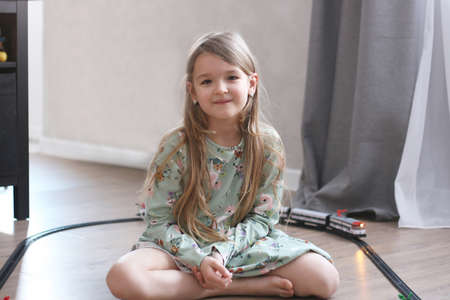 Girl plays with a toy railwayの写真素材