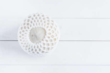 Tropical drinking coconut on white wood background.の写真素材