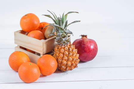 Group of fresh tropical fruits in small wooden box.の写真素材