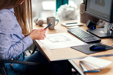 Close up business woman working at office and using smart phone.の写真素材