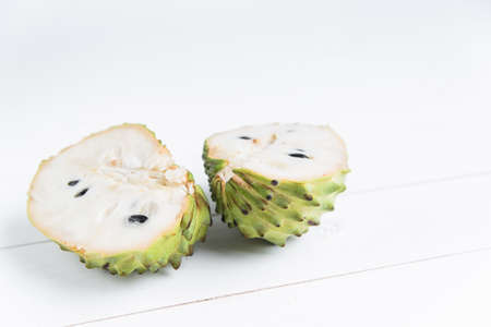 Fresh exotic tropical fruit. Two halfs of custard apple isolated on white background, annona cherimoya.の写真素材