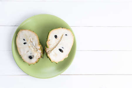 Fresh exotic tropical fruit. Two halfs of custard apple isolated on white background, annona cherimoya.の写真素材