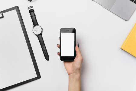 Smart phone with blank copy space screen in female hand.