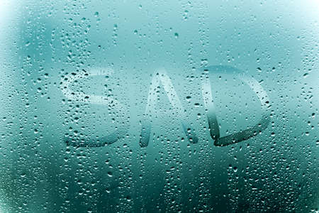the inscription sad on the sweaty glass