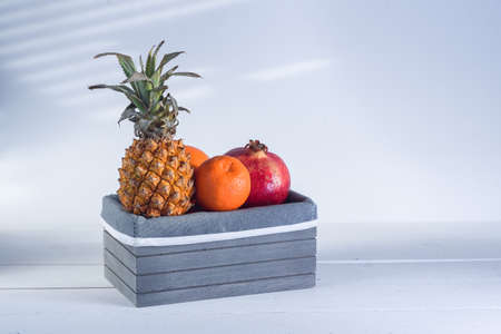 Fresh tropical fruits in grey wooden box.の写真素材